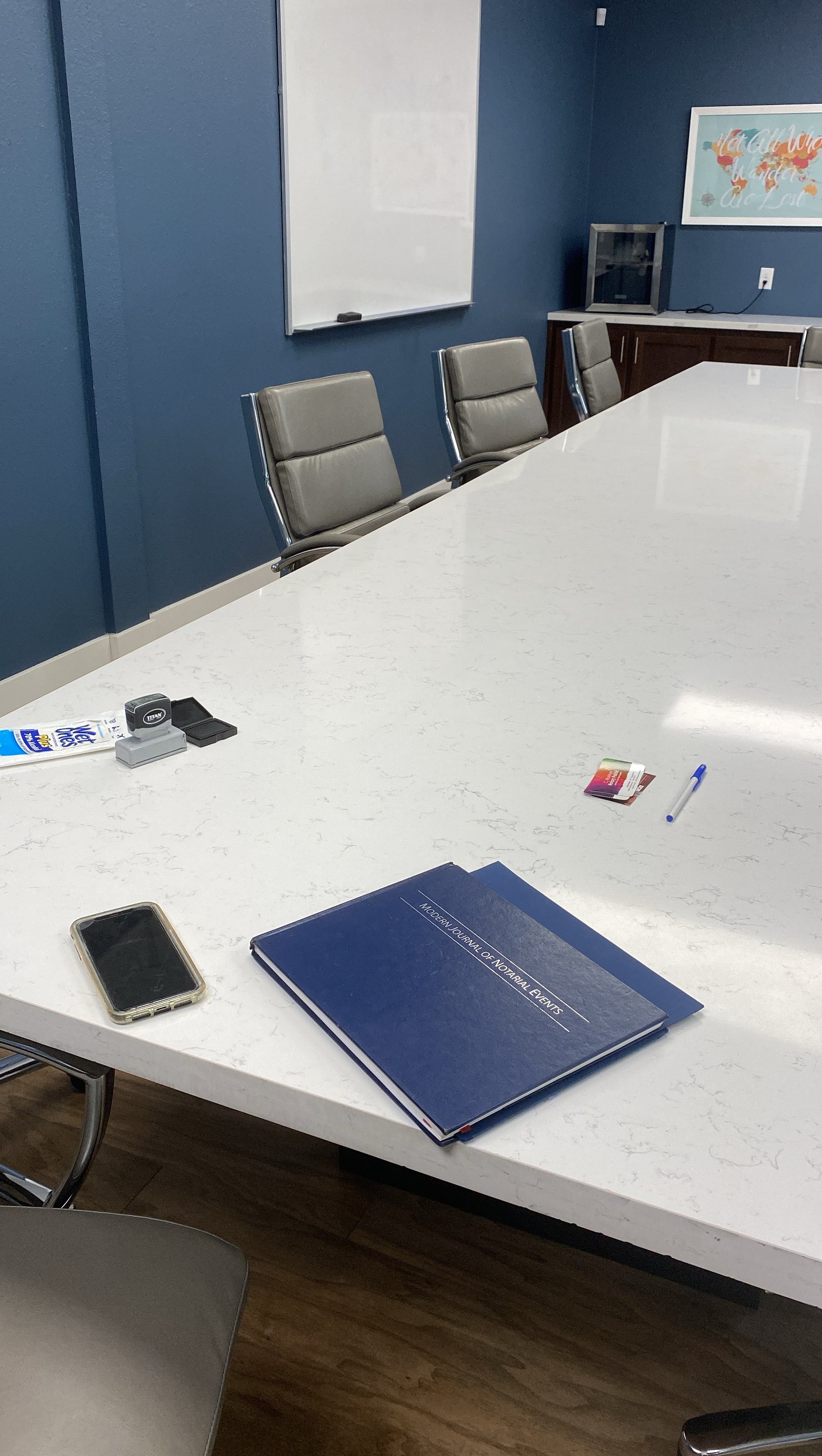Professional notary journal and supplies on conference room table — A Great Notary LLC